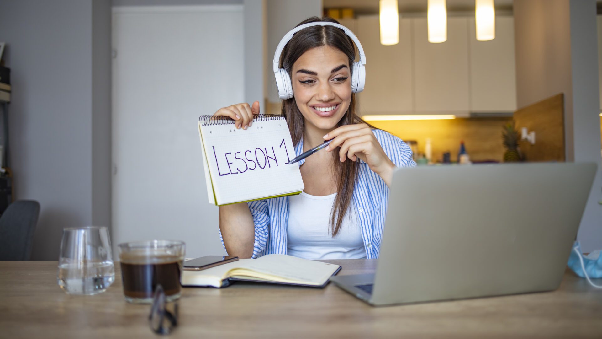 Woman teaching lesson online with laptop.