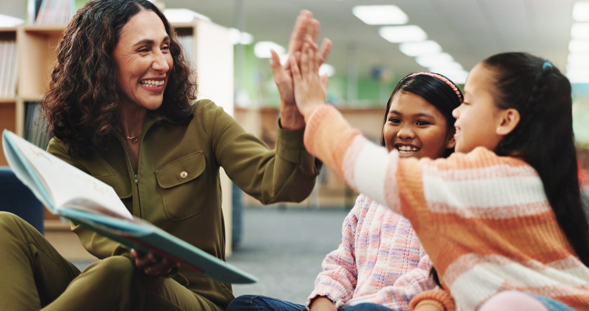 Teacher and students sharing a high-five.