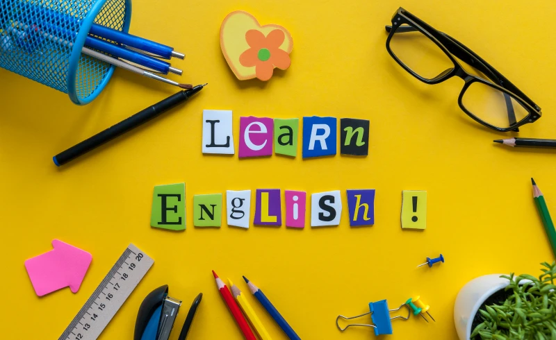 Learn English text with stationery items.