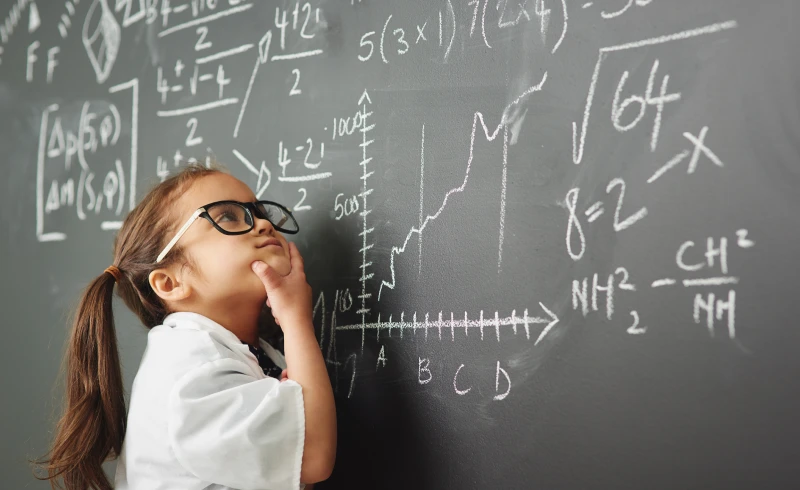 Girl thinking in front of chalkboard equations.